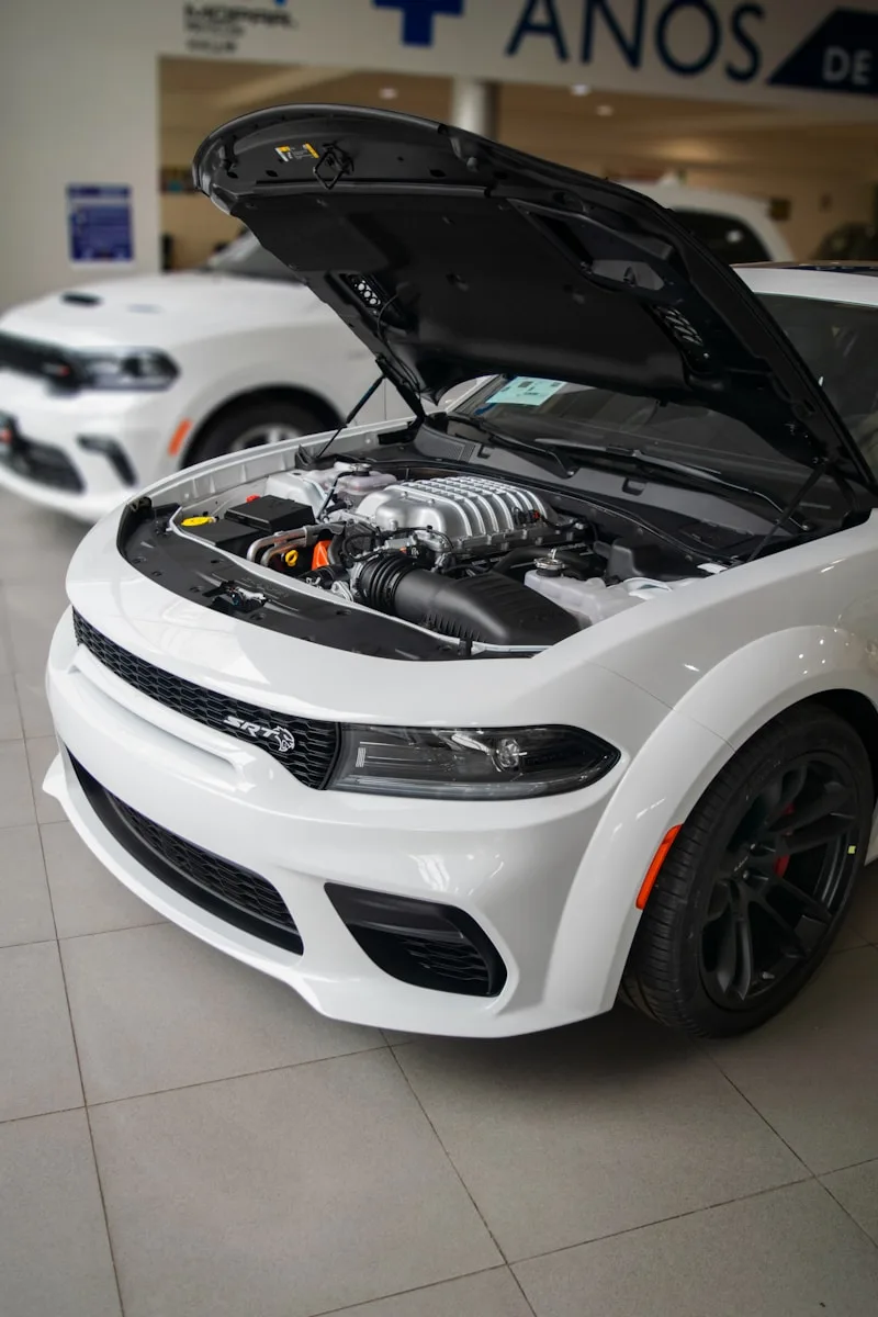a white sports car with its hood open