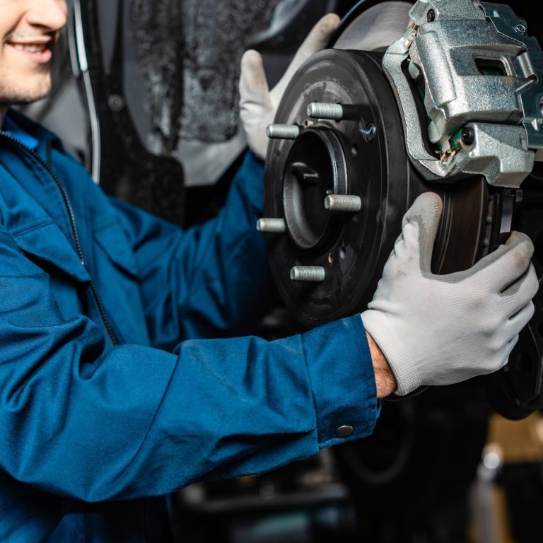 cropped view of mechanic adjusting disc brakes